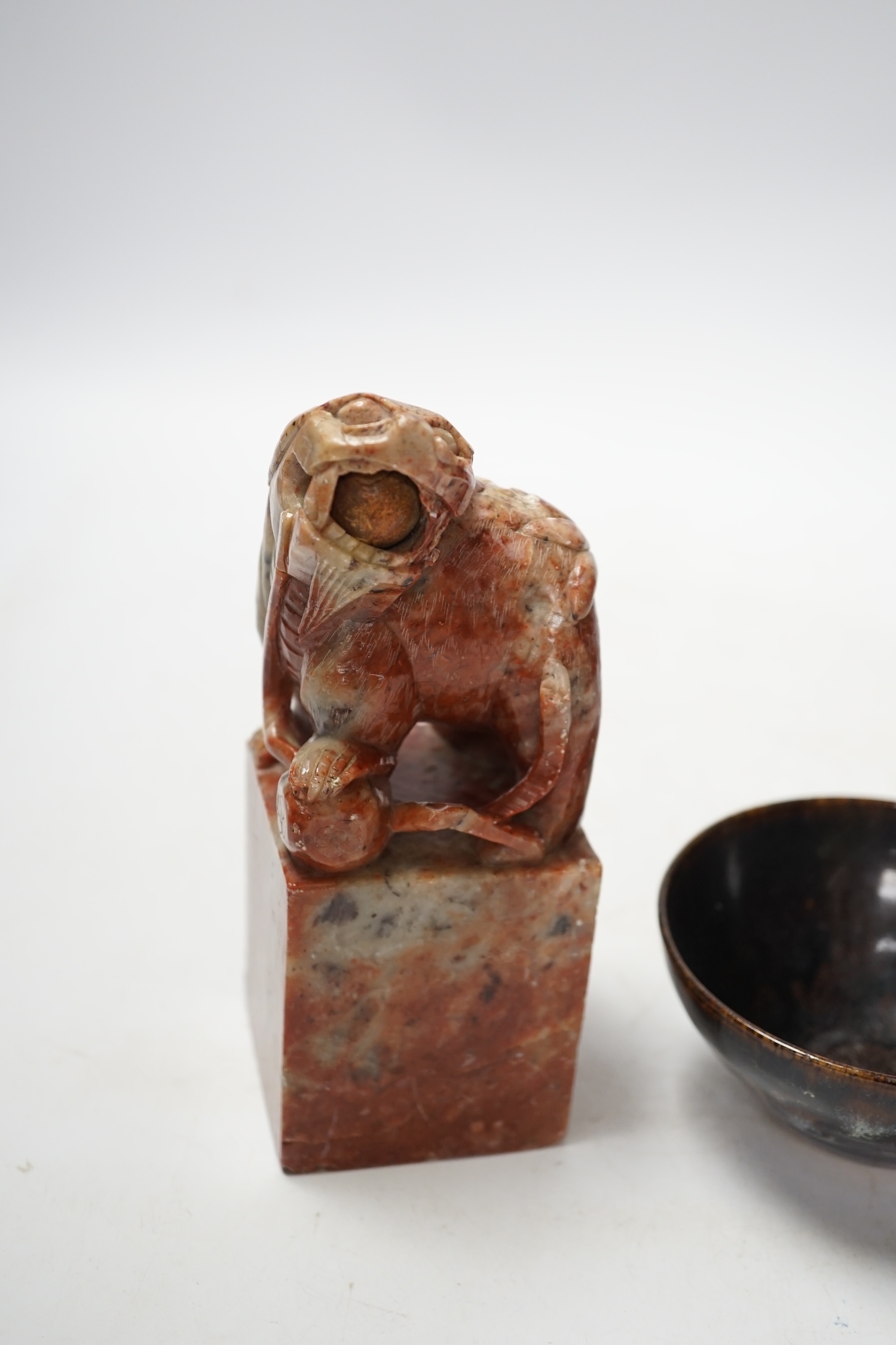 A large Chinese carved soapstone ‘lion dog’ seal and a ‘hares fur’ bowl, largest 17cm. Condition - fair